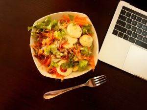 salad next to laptop