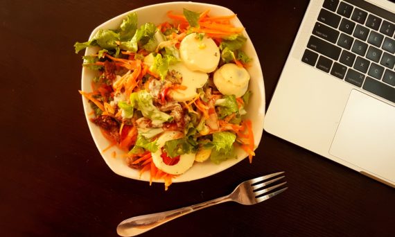 salad next to laptop