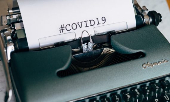 Paper in typewriter with text "#COVID19