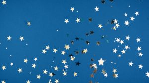 Gold star confetti on blue background