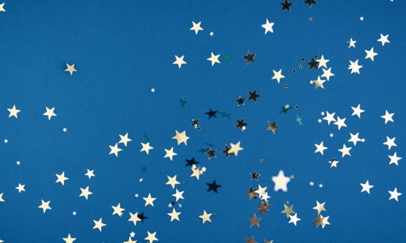 Gold star confetti on blue background